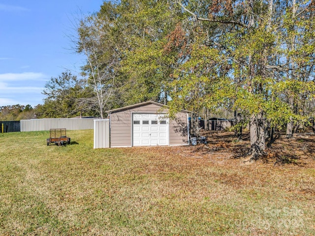 view of yard featuring a garage and an outdoor structure