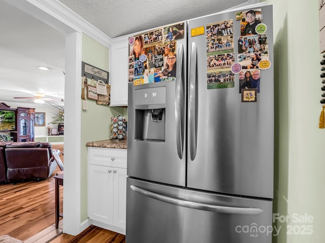 226 Mcswain Rd, Forest City, NC 28043 - kitchen with stainless steel fridge, wood finished floors, white cabinetry, a textured ceiling, and ceiling fan