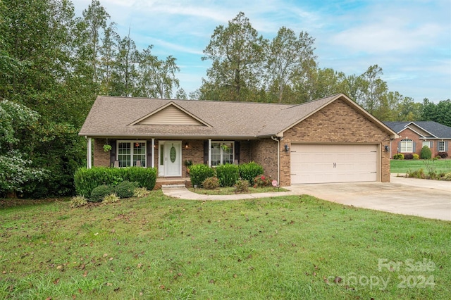 single story home with a garage and a front lawn