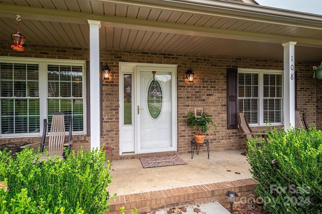 doorway to property featuring a porch