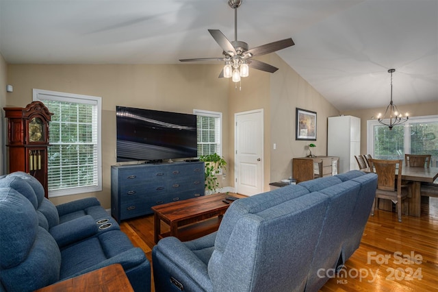 living room featuring ceiling fan with notable chandelier, dark hardwood / wood-style floors, and lofted ceiling