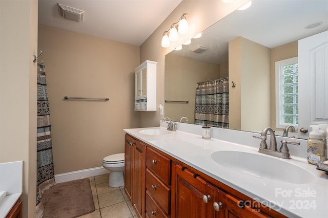 bathroom featuring tile patterned flooring, vanity, and toilet