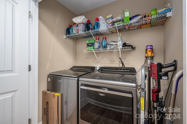 clothes washing area featuring washing machine and clothes dryer and wood-type flooring