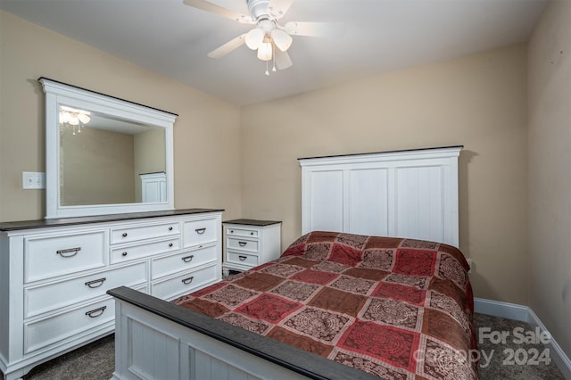 bedroom with ceiling fan and dark carpet