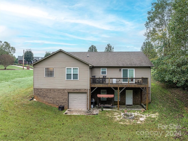 back of property featuring a yard, a deck, and a garage