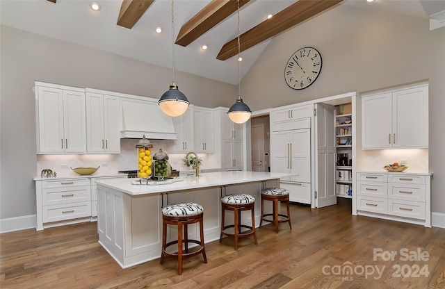 kitchen with beamed ceiling, white cabinetry, high vaulted ceiling, and tasteful backsplash