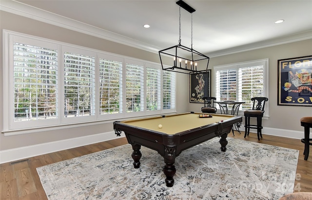 game room with pool table, wood-type flooring, a notable chandelier, and ornamental molding