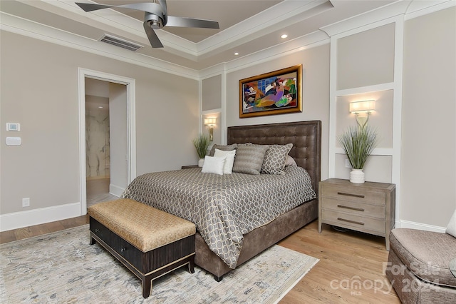 bedroom featuring wood-type flooring, ensuite bath, ceiling fan, and crown molding