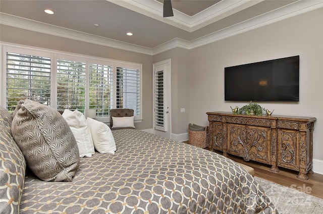 bedroom with wood-type flooring, ceiling fan, and ornamental molding