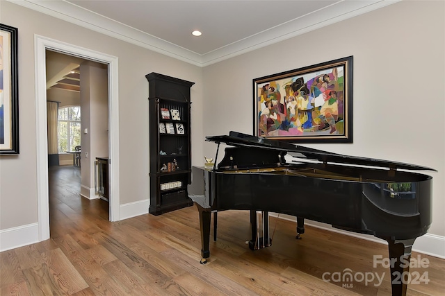 miscellaneous room with hardwood / wood-style flooring and ornamental molding