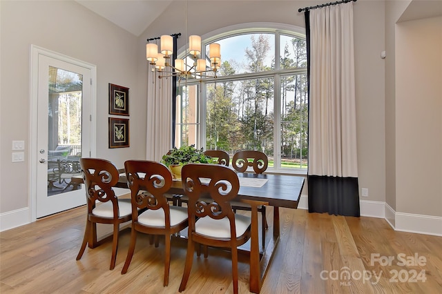 dining space featuring light hardwood / wood-style floors, an inviting chandelier, and a wealth of natural light