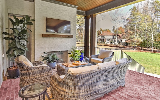 view of patio with an outdoor living space with a fireplace