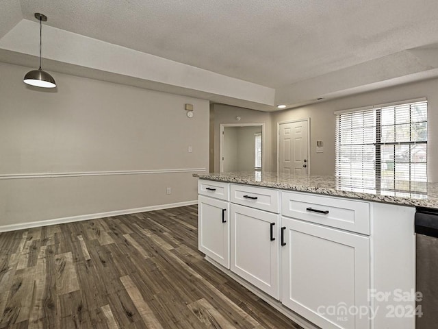 kitchen featuring white cabinetry, light stone countertops, dark hardwood / wood-style floors, a textured ceiling, and decorative light fixtures