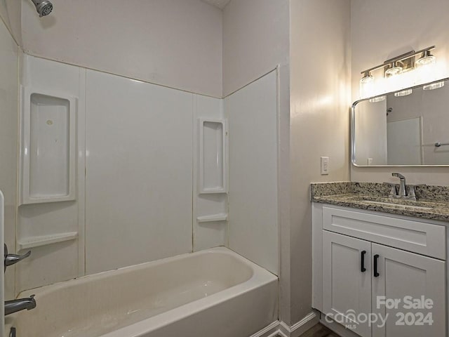 bathroom featuring vanity and  shower combination