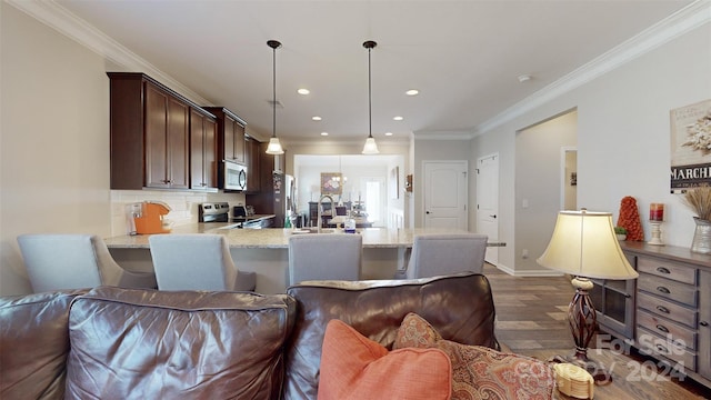 kitchen featuring crown molding, dark hardwood / wood-style floors, decorative backsplash, decorative light fixtures, and stainless steel appliances