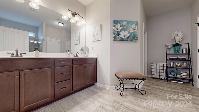 bathroom with a shower and vanity