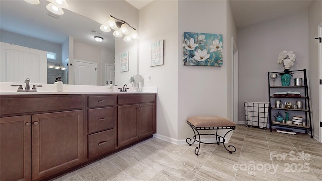280 Kerri Dawn Ln, Locust, NC 28097 - bathroom featuring a shower stall, double vanity, and baseboards