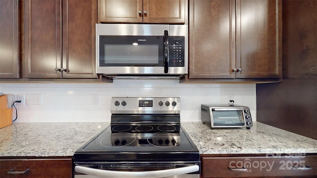 280 Kerri Dawn Ln, Locust, NC 28097 - kitchen featuring appliances with stainless steel finishes, dark brown cabinets, and decorative backsplash