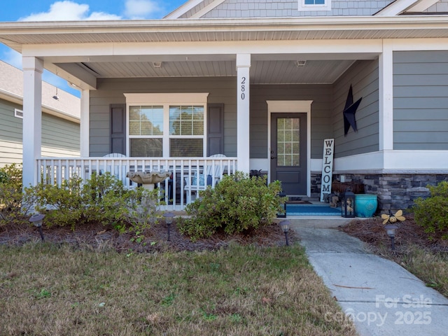 280 Kerri Dawn Ln, Locust, NC 28097 - view of exterior entry featuring a porch and stone siding