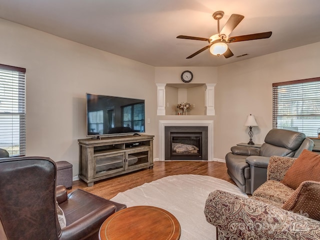 living room with ceiling fan and light wood-type flooring