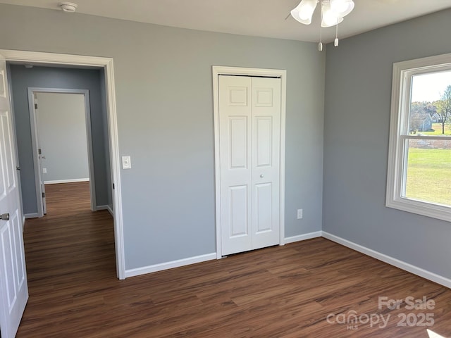 3596 Bethany Church Rd, Claremont, NC 28610 - unfurnished bedroom with dark wood finished floors, baseboards, and a closet