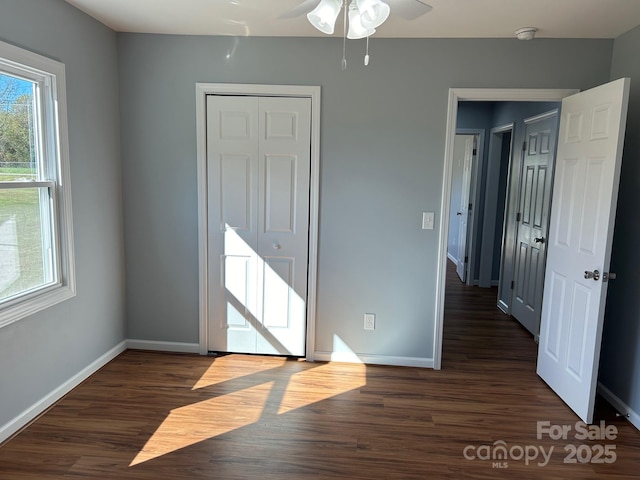 3596 Bethany Church Rd, Claremont, NC 28610 - unfurnished bedroom featuring baseboards, dark wood-style floors, and a closet