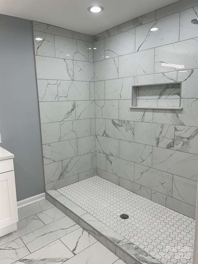 3596 Bethany Church Rd, Claremont, NC 28610 - bathroom with marble look tile flooring, recessed lighting, a tile shower, and baseboards