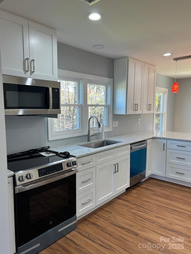 3596 Bethany Church Rd, Claremont, NC 28610 - kitchen featuring appliances with stainless steel finishes, a sink, white cabinets, dark wood finished floors, and recessed lighting