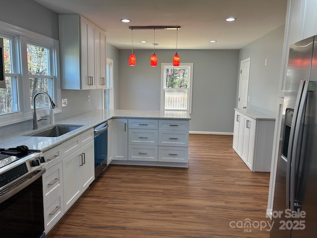 3596 Bethany Church Rd, Claremont, NC 28610 - kitchen featuring appliances with stainless steel finishes, a sink, a peninsula, dark wood-style floors, and white cabinets
