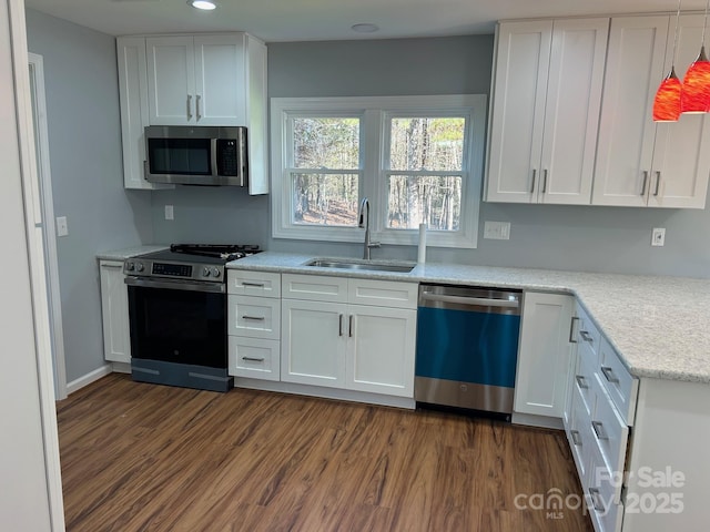 3596 Bethany Church Rd, Claremont, NC 28610 - kitchen featuring stainless steel appliances, a sink, white cabinets, dark wood-style floors, and recessed lighting