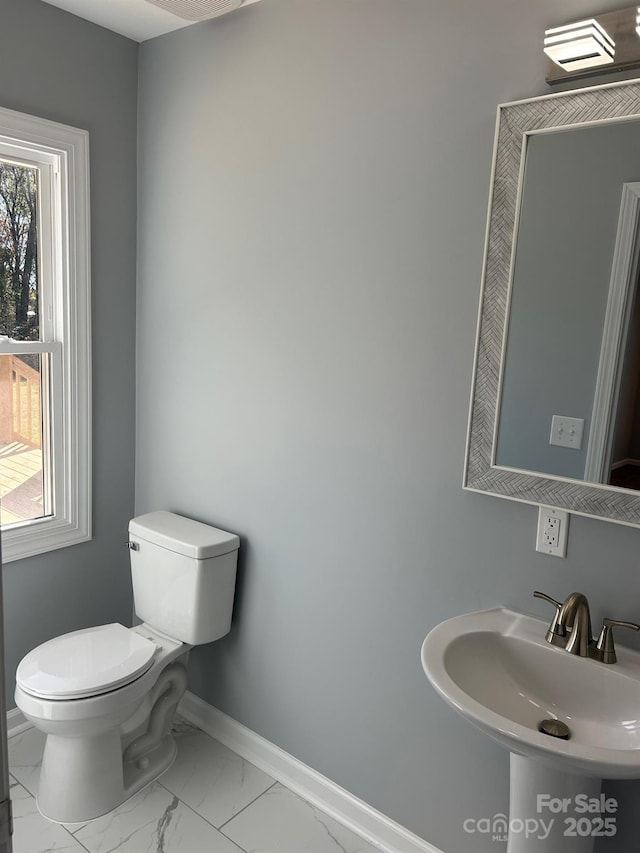 3596 Bethany Church Rd, Claremont, NC 28610 - bathroom featuring a sink, baseboards, marble finish flooring, and toilet