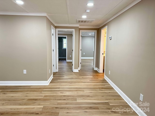 hallway featuring light hardwood / wood-style flooring and ornamental molding