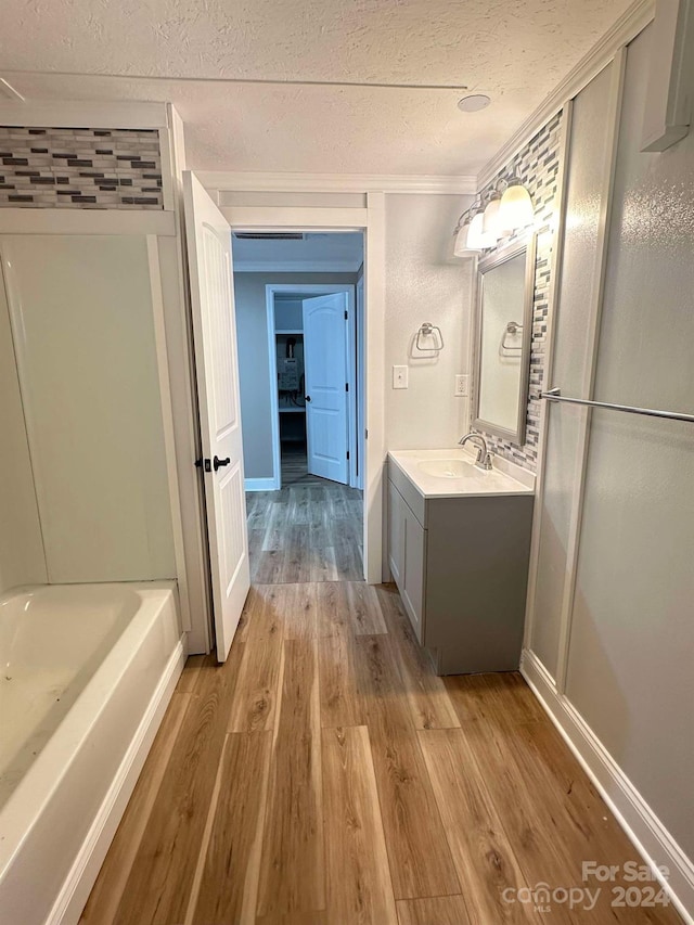 bathroom with hardwood / wood-style floors, vanity, and ornamental molding