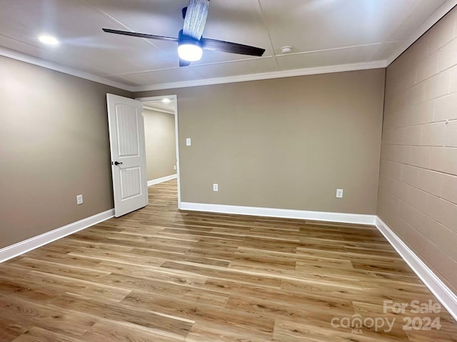 spare room featuring hardwood / wood-style flooring, ceiling fan, and ornamental molding