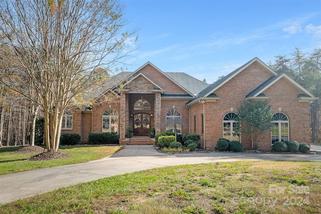 view of front facade featuring french doors and a front lawn