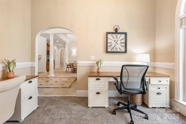 home office with ornate columns, carpet, and a healthy amount of sunlight