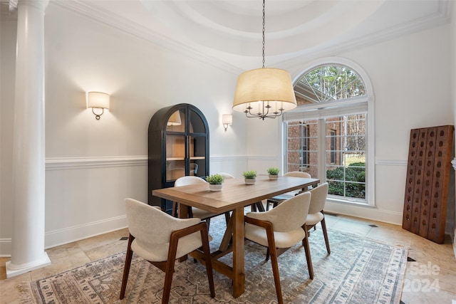 dining area with a raised ceiling, ornate columns, and plenty of natural light