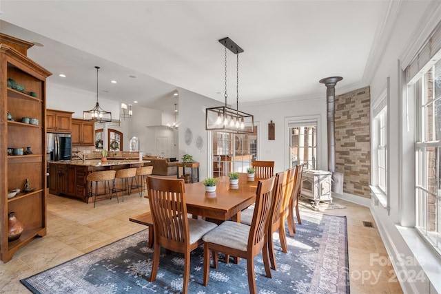 dining area featuring a chandelier and ornamental molding