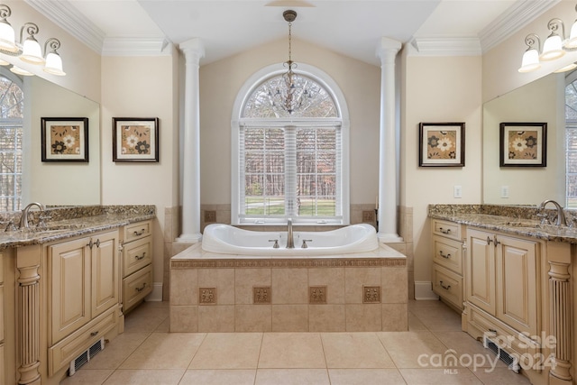 bathroom with decorative columns, vanity, crown molding, tiled tub, and tile patterned flooring