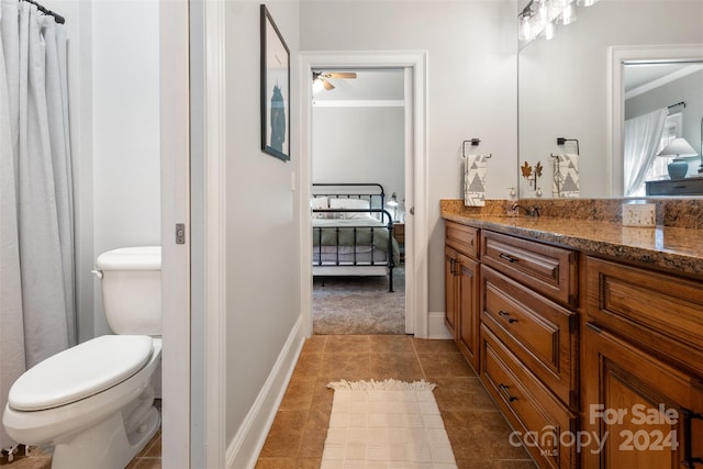 bathroom with crown molding, tile patterned flooring, vanity, and toilet