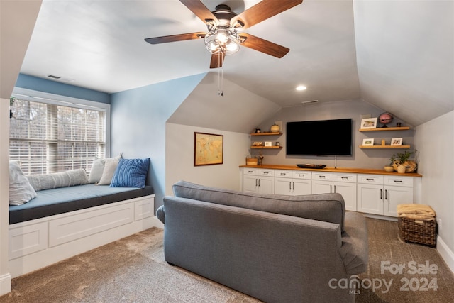 carpeted living room with ceiling fan and lofted ceiling