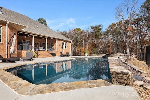 view of pool with ceiling fan and a patio area