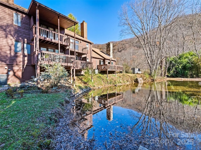 exterior space with a water and mountain view