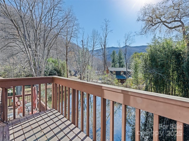 wooden deck with a mountain view