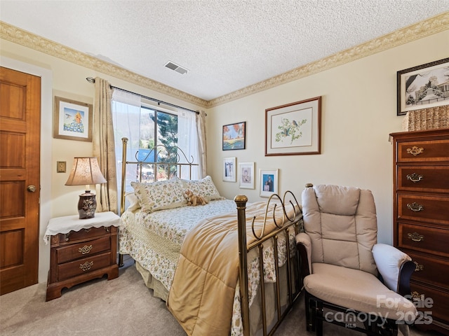 carpeted bedroom featuring a textured ceiling