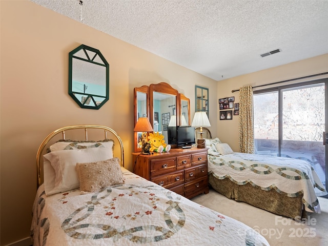 carpeted bedroom with a textured ceiling