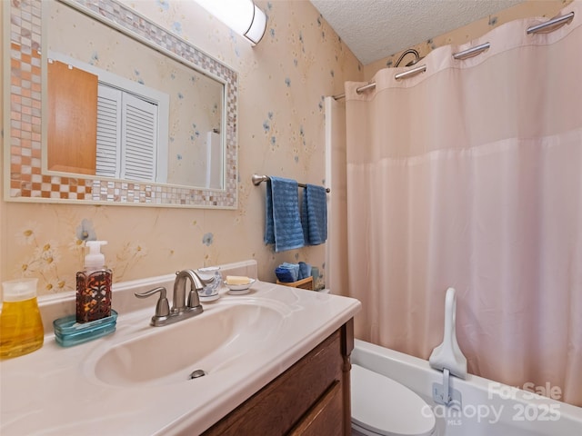 full bathroom with vanity, shower / bath combo, toilet, and a textured ceiling