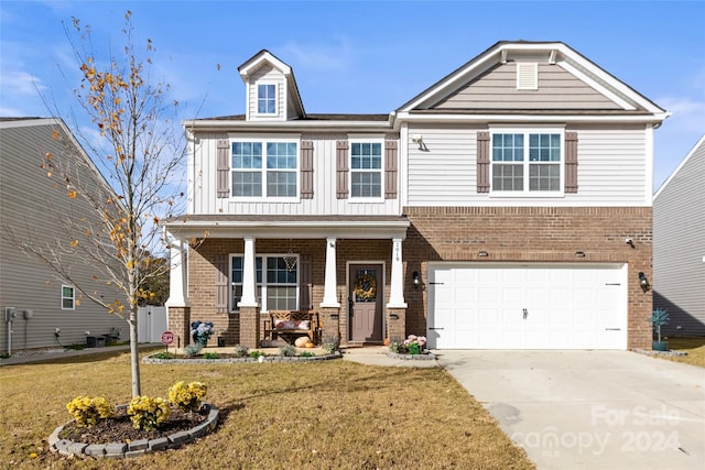 view of front of home with a front yard and a garage