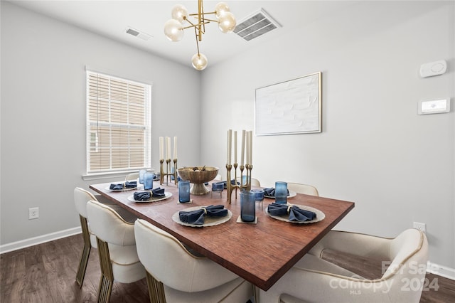 dining area with dark hardwood / wood-style flooring and a chandelier