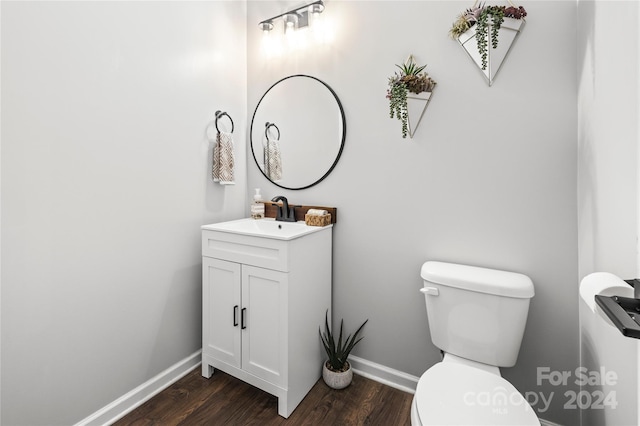 bathroom featuring hardwood / wood-style flooring, vanity, and toilet